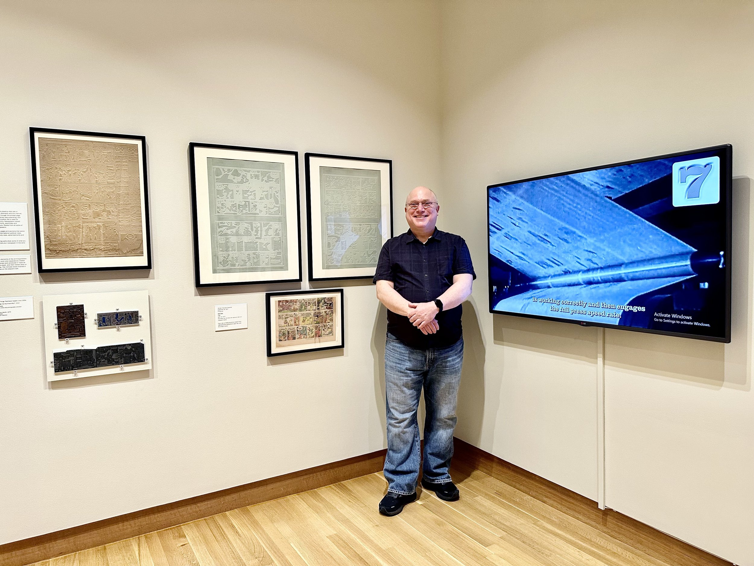 Man documents comics printing! To my left is the video I created for the exhibition, showing the process of taking a cartoonist’s drawing from board to newspaper during the era of metal printing from the 1910s to 1980s.