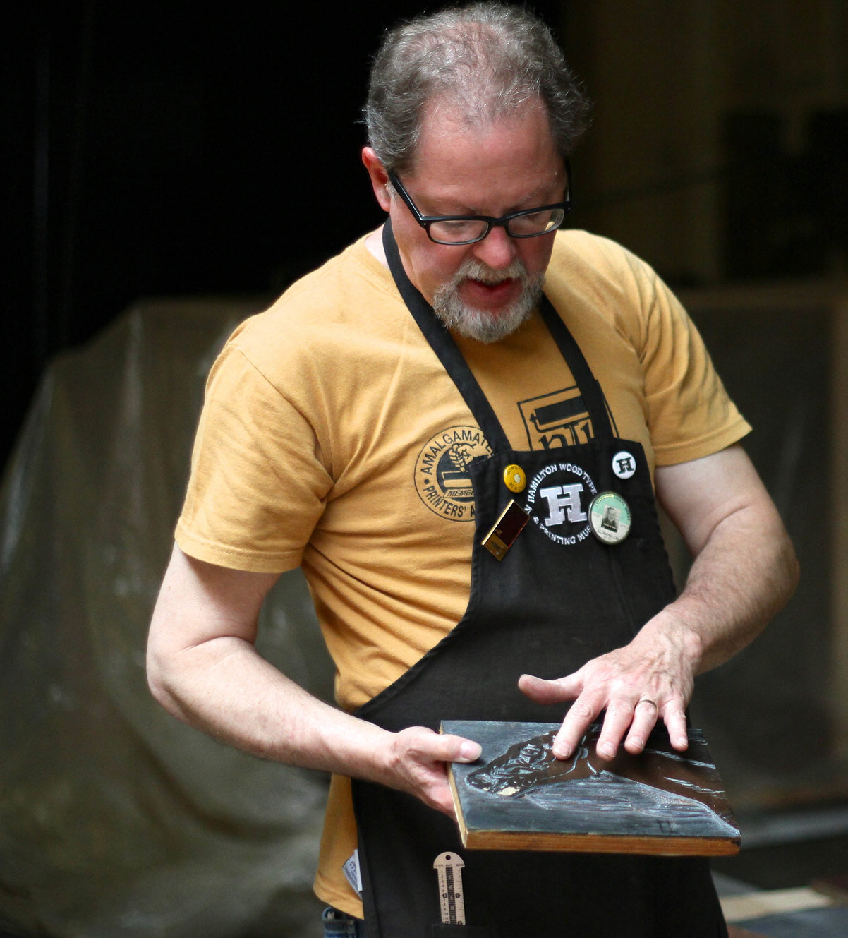 Jim Moran holding a wood block (photo by Jacqui Cheng for The Magazine )